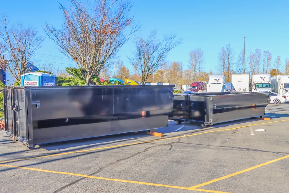 Professional dumpster rental service with roll-off container on residential driveway in Wyandotte